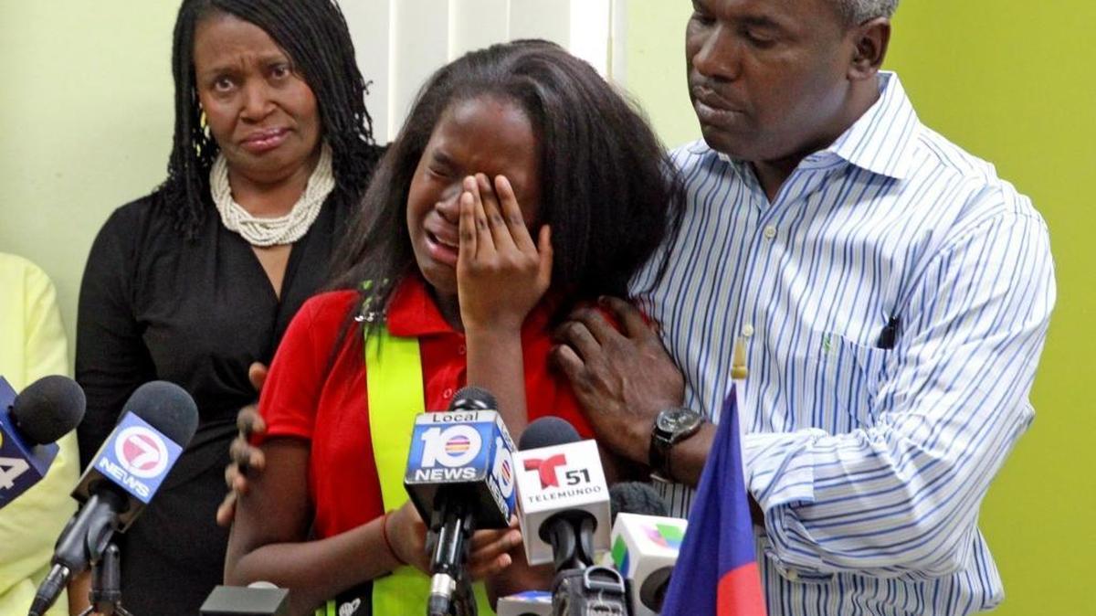 Ronyde Christina Ponthieux, 10, cries with her father Rony Ponthieux by her side, as she speaks to the media about the Trump administration’s decision to end TPS for thousands of Haitians, Nov. 21, 2017.