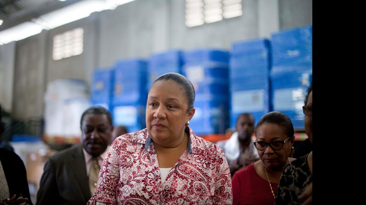 
In this Sept. 10, 2014, file photo, Haiti's first lady Sophia Martelly visits a warehouse housing a donation of kits to treat chikungunya in the Cite Soleil slum in Port-au-Prince, Haiti. An elections committee in Haiti has the rejected first lady's bid to run for Senate. 
