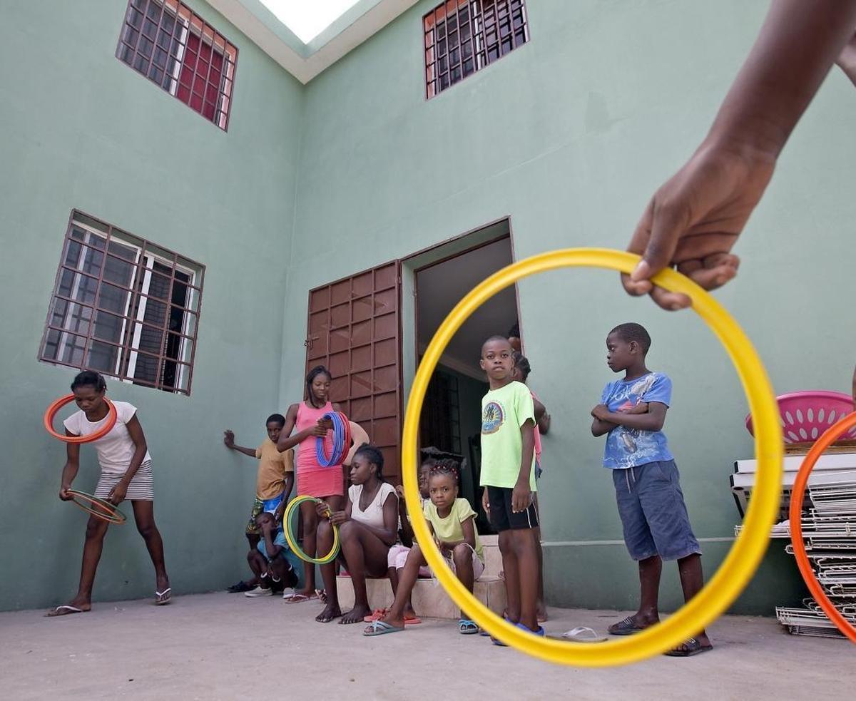 Children at the New Hope 4 Haiti orphanage in Les Cayes, Haiti play in the courtyard of their new home. Michele King Soffer, a South Florida philanthropist of Haitian descent, bought the unfinished three-bedroom house, and renovated it to include 11 other bedrooms for the orphanage’s 34 kids.