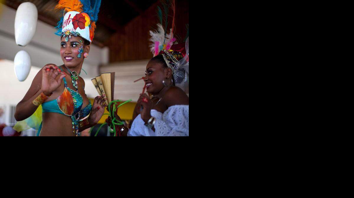 
Carnival Queen Fabienne Francois dances at Carnival celebrations in Jacmel, Haiti, Sunday, Feb. 23, 2014. The Carnival spirit will take hold again this weekend in Jacmel as its annual parade snakes through the downtown of the coastal town in a warm up to Haiti’s National Carnival Feb. 15, 16 and 17, which returns to Port-au-Prince this year. 
