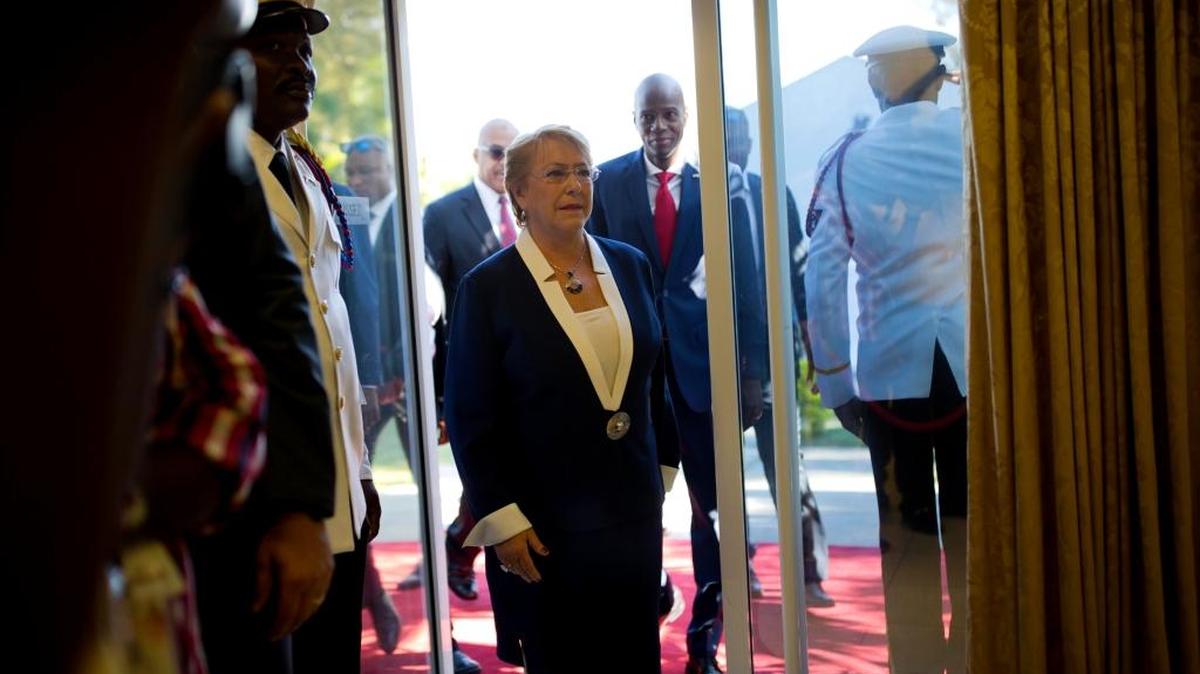 Chile's President Michelle Bachelet is followed by Haiti's President Jovenel Moise as she arrives to the National Palace in Port-au-Prince, Haiti, Monday, March 27, 2017.