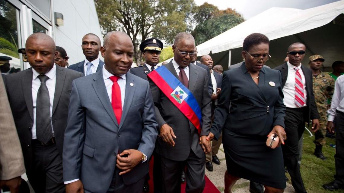 Haiti’s provisional President Jocelerme Privert, center right, walks with his wife Ginette Michaud and Chamber of Deputies President Cholzer Chancy, left front, during his installation ceremony, in Port-au-Prince, Haiti, Sunday, Feb. 14, 2016.