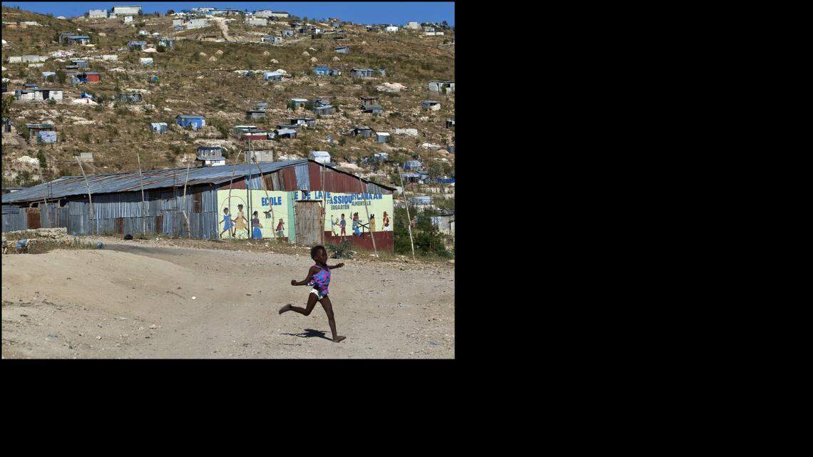 Claudia Saint-Elys, 5, runs near her family's market in Canaan, a neighborhood on the outskirts of Port-au-Prince that sprung up shortly after the 2010 earthquake on Thursday, Jan. 9, 2014.