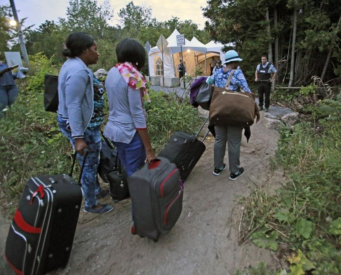 Haitian migrants living in the United States prepare to cross the U.S.-Canadian border along Roxham Road in August 2017. Thousands of Haitians crossed over in to Canada from an irregular crossing near the Champlain-St. Bernard de Lacolle border in hopes of finding residency in Canada.