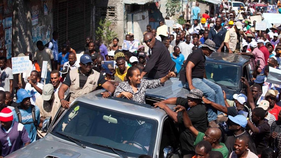 Former presidential candidate Maryse Narcisse greets supporters chanting “Maryse for president!” during a protest demanding last year’s two general election votes be recounted in Port-au-Prince, Haiti, Monday, Feb. 29, 2016. The protest also marked the 12th year since the ouster of President Jean-Bertrand Aristide.