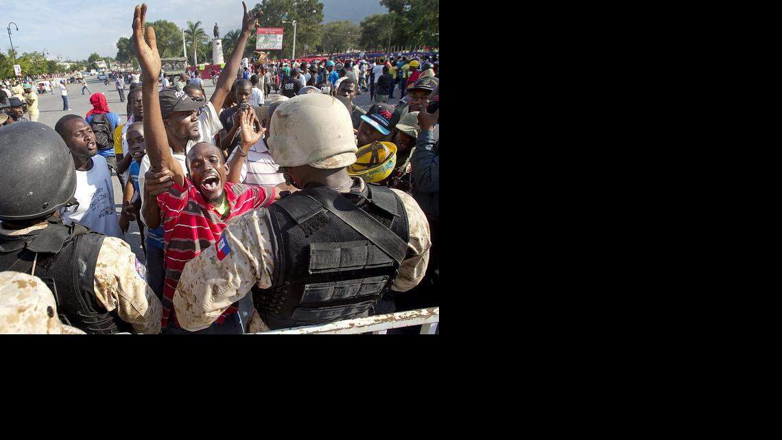 
Franck Francois (striped shirt) voices his opposition to the government of Michel Martelly in downtown Port au Prince, Haiti on Saturday December 13, 2014. As Haiti approaches the fifth anniversary of its devastating Jan. 12, 2010 earthquake, growing discontent among Haiti's poor, black masses is growing increasing anti-government demonstrations and calls for President Michel J. Martelly to step down.
