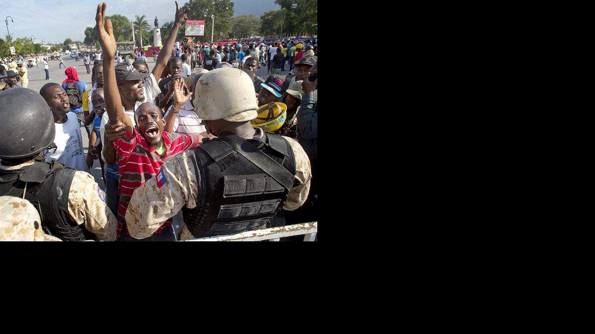 
Franck Francois (striped shirt) voices his opposition to the government of Michel Martelly in downtown Port au Prince, Haiti on Saturday December 13, 2014. As Haiti approaches the fifth anniversary of its devastating Jan. 12, 2010 earthquake, growing discontent among Haiti's poor, black masses is growing increasing anti-government demonstrations and calls for President Michel J. Martelly to step down.

