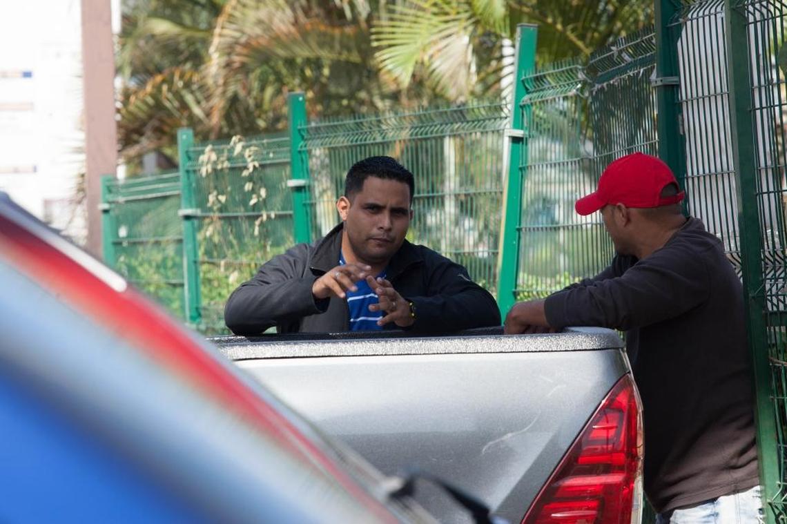 “Manuel” speaks with Carlos Fonseca behind his pickup about the bullet casings and the potential assistance to the family.