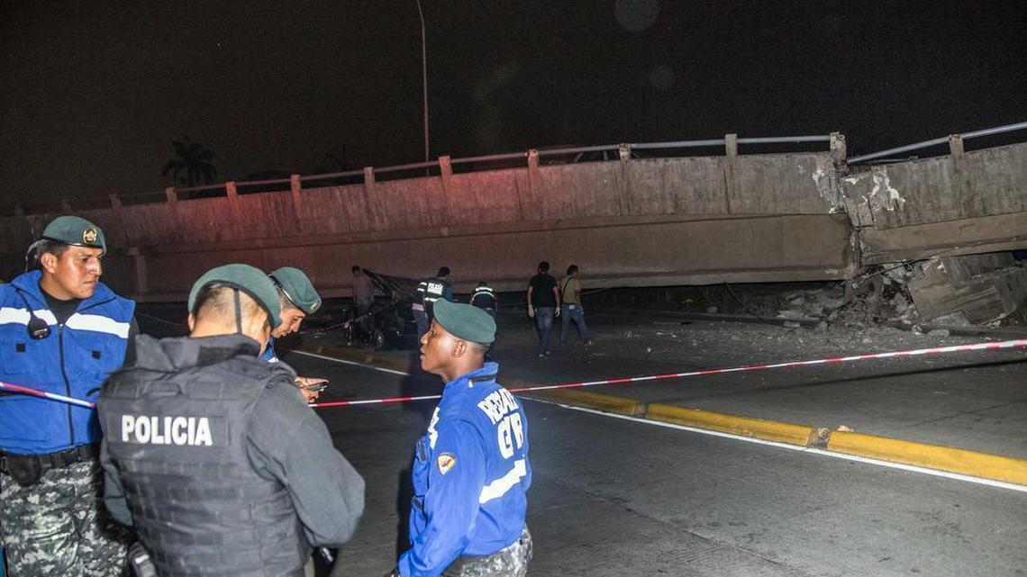 Police officers stand next to a collapsed overpass in Guayaquil, Ecuador, Saturday April 16, 2016. The strongest earthquake to hit Ecuador in decades flattened buildings and buckled highways along the country's coast.