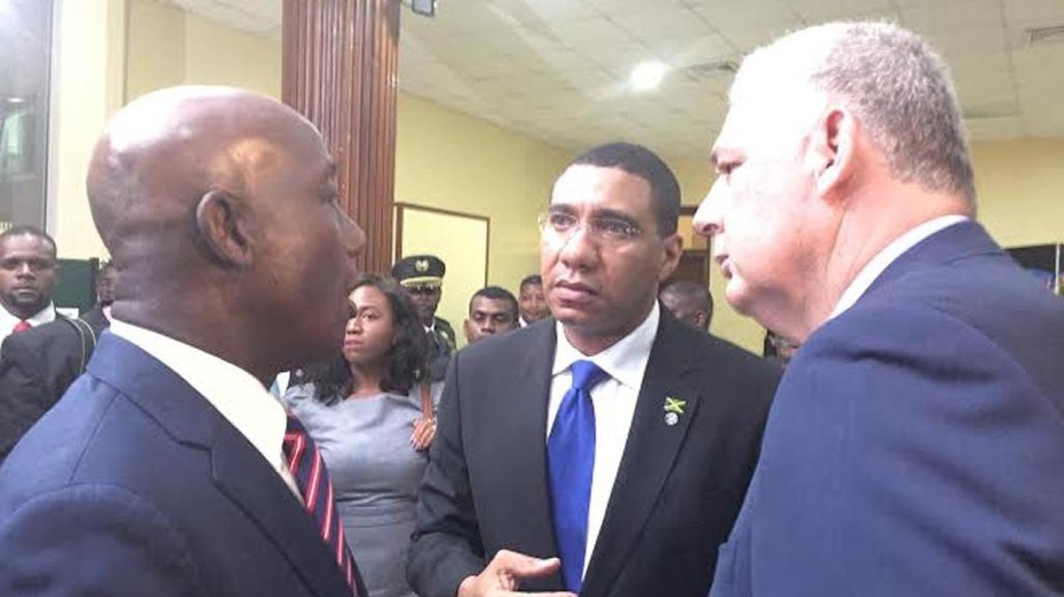 Trinidad and Tobago Prime Minister Keith Rowley speaks to Jamaica Prime Minister Andrew Holness and St. Lucia Prime Minister Allen Chastanet after all three gave opening remarks at an annual summit of the Caribbean Community in Georgetown, Guyana.