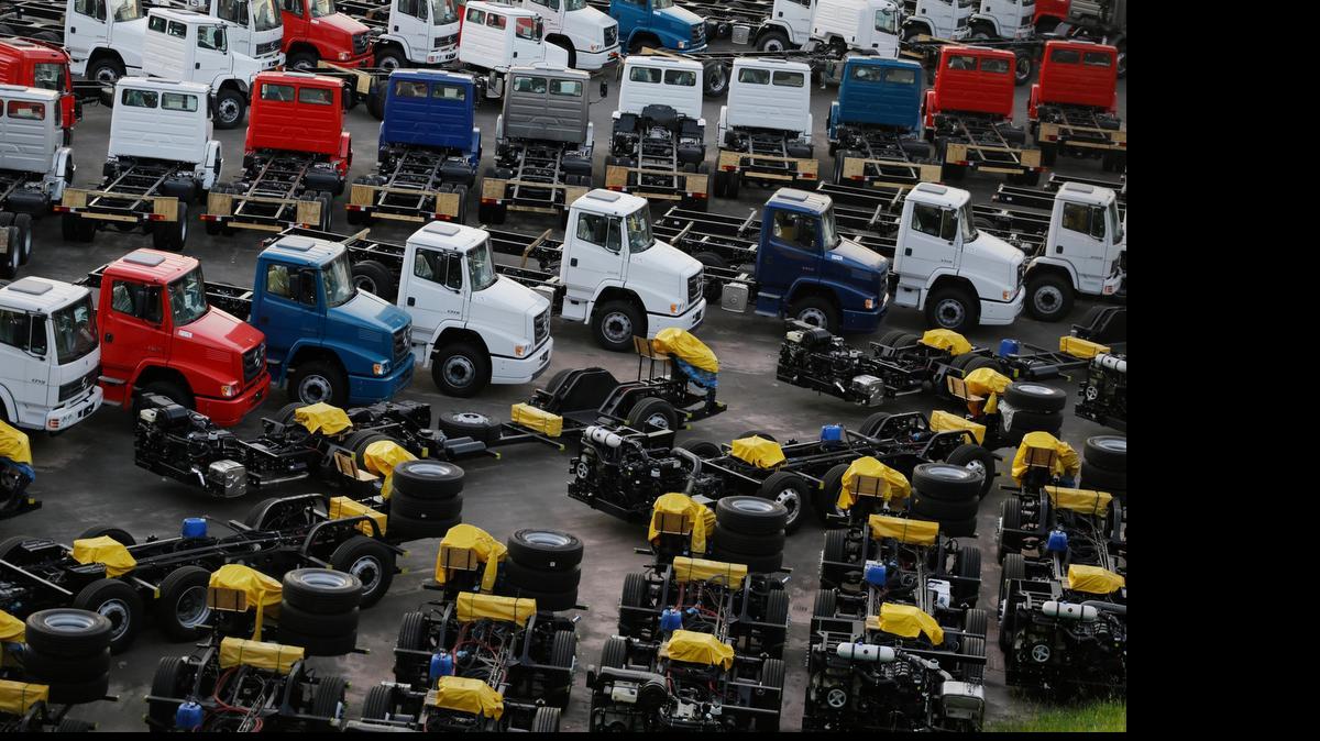 
Ailing Brazil — In this June 10, 2015 photo, new trucks and parts sit at a Mercedes-Benz park in Sao Bernardo do Campo, Brazil. Mercedes-Benz said in a statement that “the sharp drop in bus and truck sales” had forced it last month to rescind the contracts of 500 workers who had been furloughed several months earlier. 
