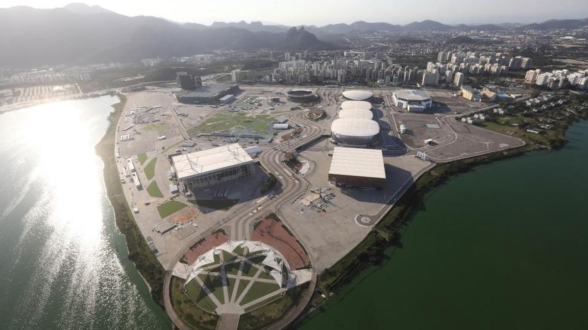 The Olympic Park stands along a polluted waterway, tinted green by algae, in Rio de Janeiro’s Barra da Tijuca neighborhood. A year since the Rio Olympics ended on Aug. 21, 2016, many of the costly venue sites are now shuttered or underused amidst a deep economic crisis in the city.
