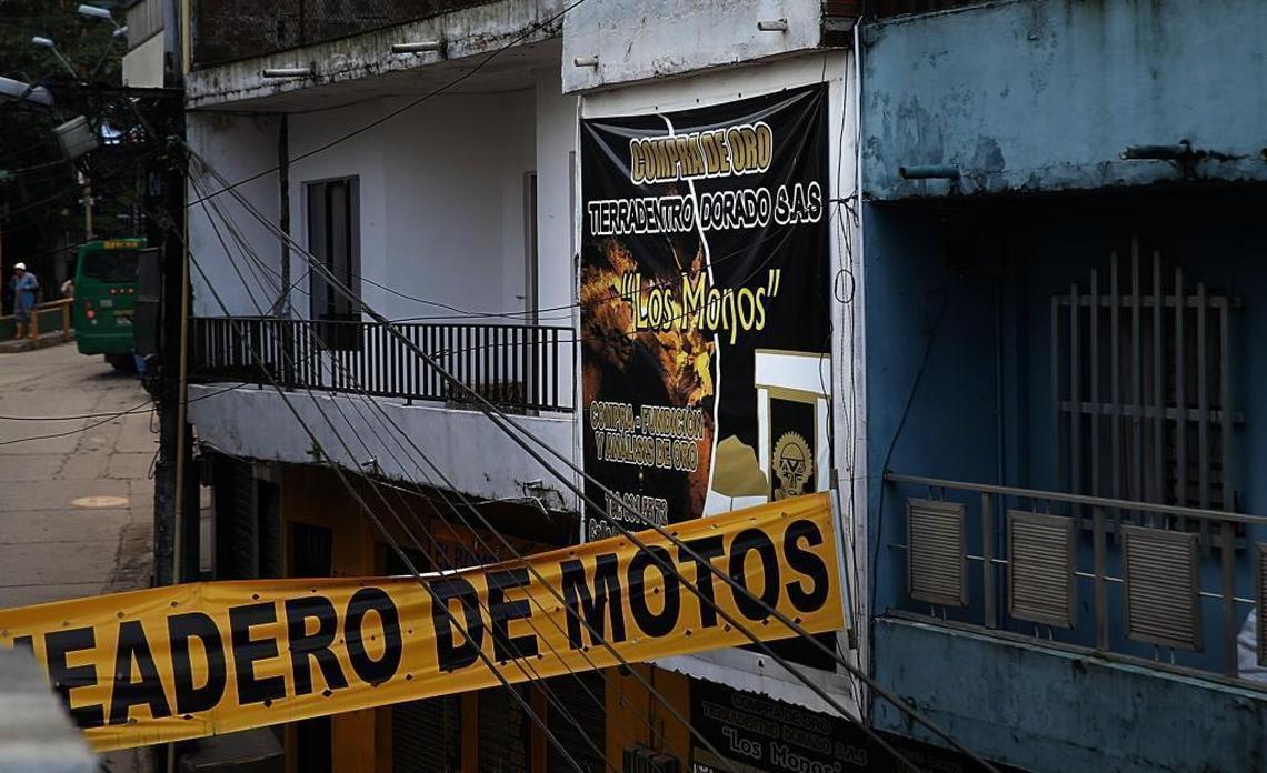 A banner advertises a gold-buying store in Segovia, a mining town in Colombia.
