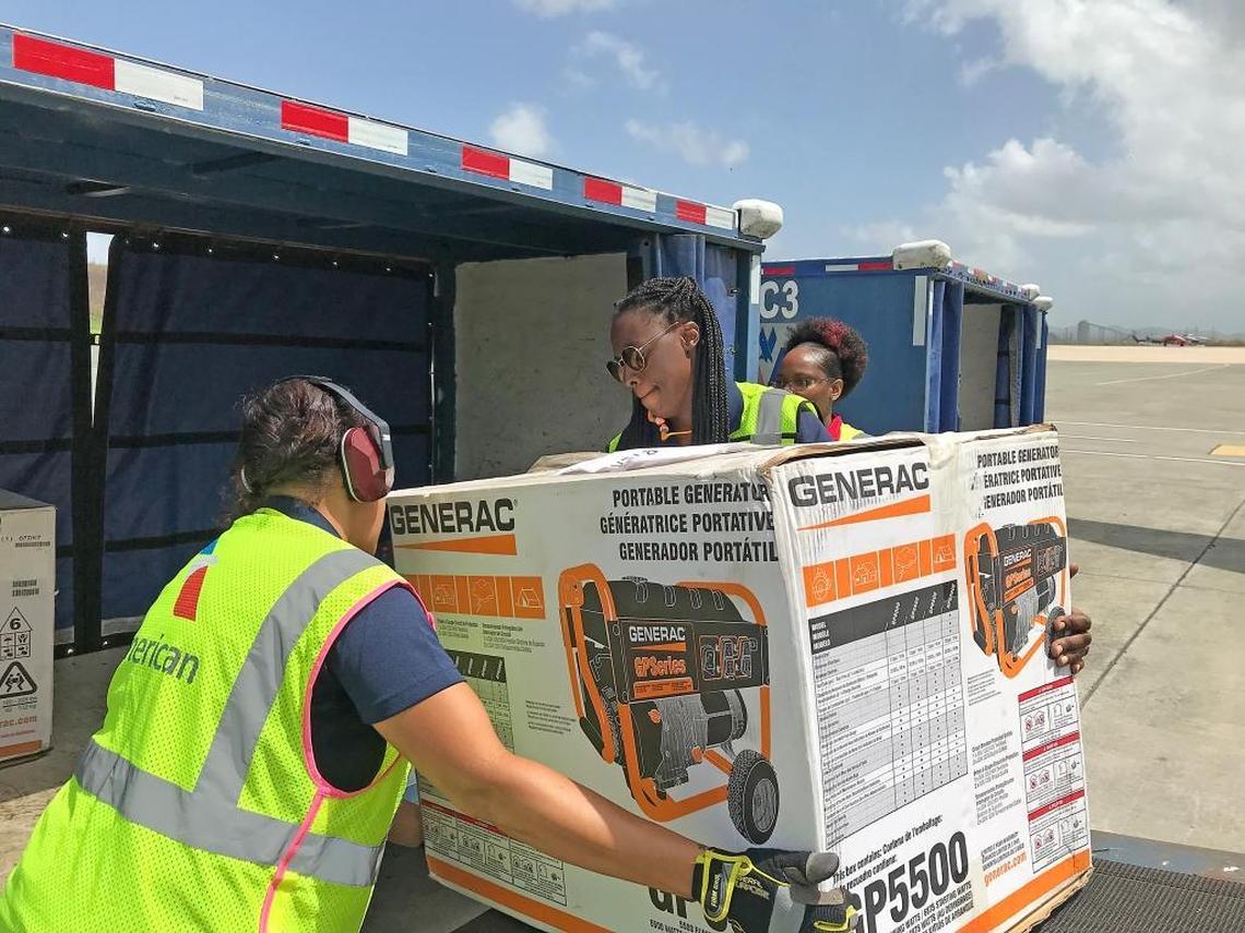 Workers in St. Croix unload an American Airlines fight that flew in 5,000 lbs of relief supplies from Miami on Tuesday and flew out 135 stranded tourists and sick residents.