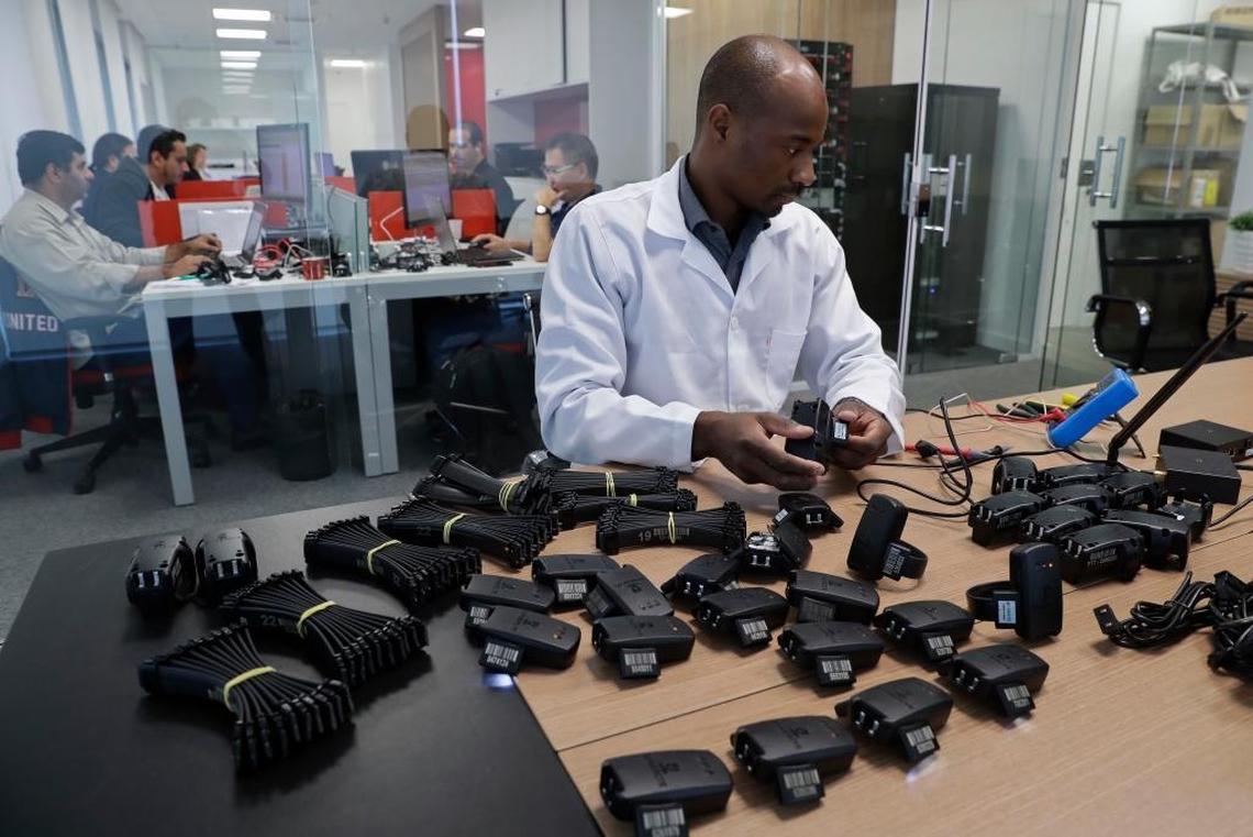 A technician tests electronic bracelets at Sao Paulo-based Synergye, a company that makes the bracelets and monitors inmates in Sao Paulo. When the massive "Car Wash" mega-corruption scandal probe began, fewer than 10,000 inmates were under house surveillance, according to the companies that provide the bracelets. Today more than 24,000 prisoners use the devices.