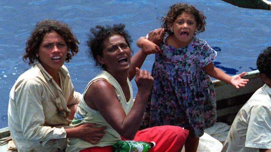 Cuban women rafters plead for rescue, during massive flotillas in fall of 1994.
