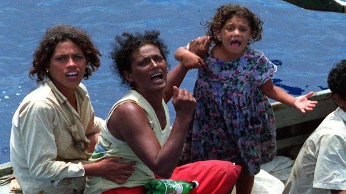 Cuban women rafters plead for rescue, during massive flotillas in fall of 1994.