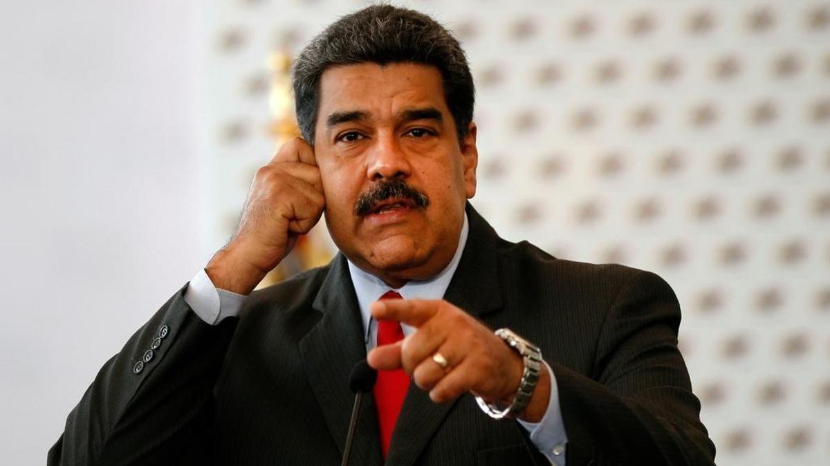 Venezuela's President Nicolas Maduro answers questions from the press after signing a document defining electoral guarantees for the presidential election at the National Electoral Council in Caracas, Venezuela, Friday, March 2, 2018.
