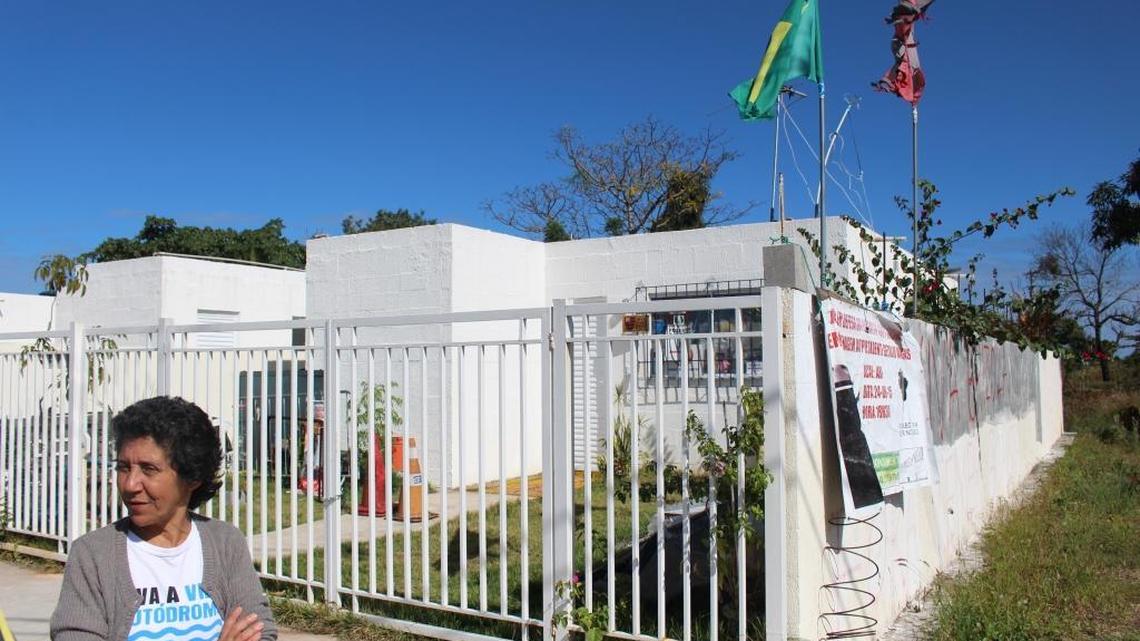 Maria da Penha Macena stands outside her new home in Vila Autódromo. She won’t move in until modifications are completed to her taste. The house is temporarily being used as a museum documenting residents’ struggle to prevent forced removal from their community.
