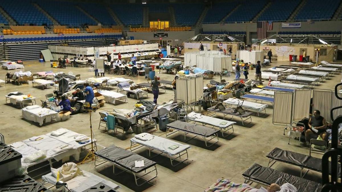 A view of medical staff working with patients at a federal medical shelter set up in a sports stadium in Manati, Puerto Rico after Hurricane Maria. The hospital is staffed by a team from the National Disaster Medical System and by volunteers from New York hospitals.
