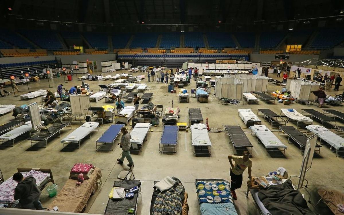 A view of medical staff working with patients at a federal medical shelter set up in a sports stadium in Manati, Puerto Rico after Hurricane Maria. The hospital is staffed by a team from the National Disaster Medical System and by volunteers from New York hospitals.