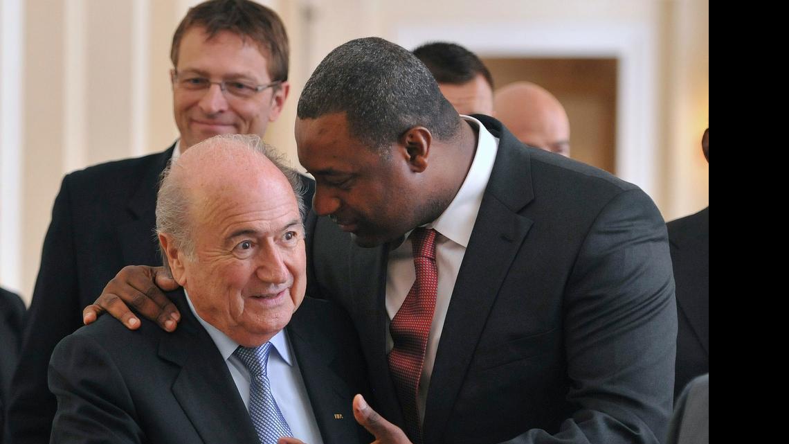 
In this Wednesday, May 23, 2012 file photo the newly elected president of CONCACAF Jeffrey Webb talks to FIFA President Sepp Blatter, left, as they arrive at the meeting of the Confederation of North, Central American and Caribbean Association Football (CONCACAF), prior to the two-day congress of FIFA in Budapest, Hungary. Webb is among several soccer officials who were arrested and detained by Swiss police on Wednesday, May 27, 2015, at the request of U.S. authorities after a raid at Baur au Lac Hotel in Zurich. 

