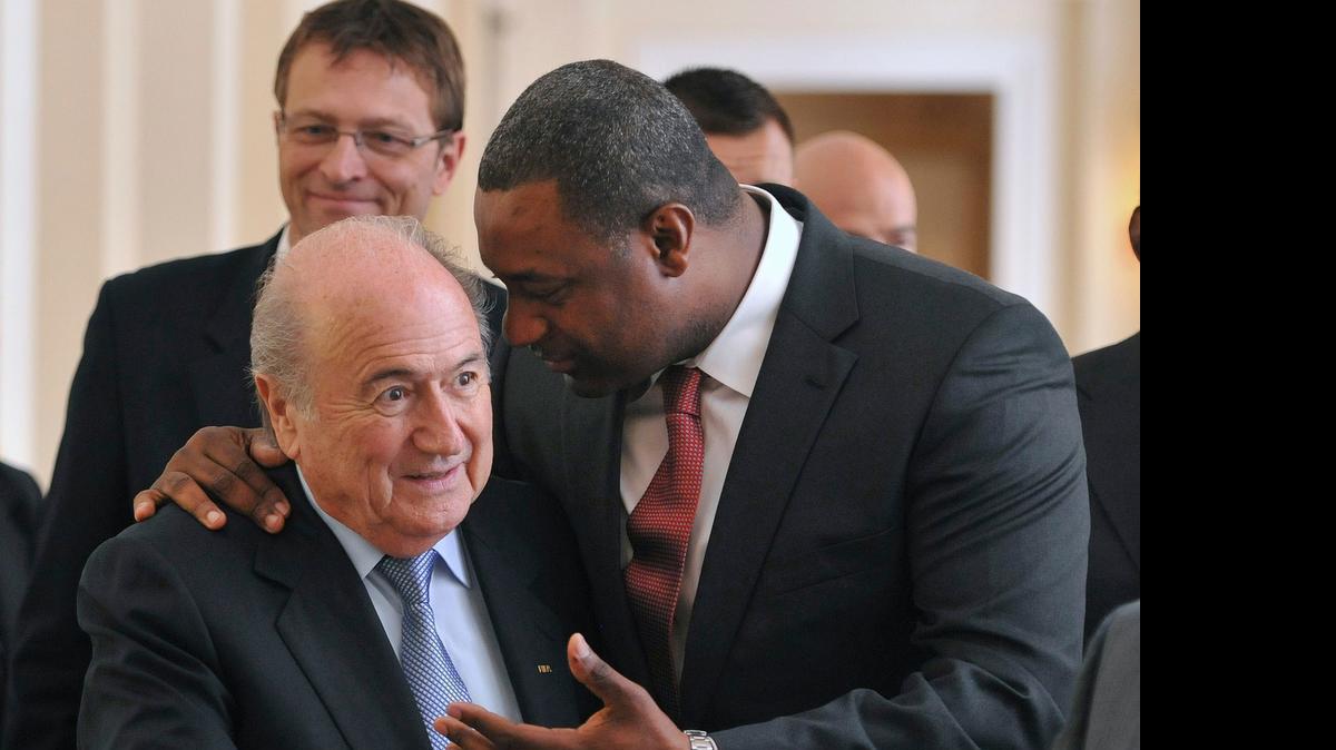 
In this Wednesday, May 23, 2012 file photo the newly elected president of CONCACAF Jeffrey Webb talks to FIFA President Sepp Blatter, left, as they arrive at the meeting of the Confederation of North, Central American and Caribbean Association Football (CONCACAF), prior to the two-day congress of FIFA in Budapest, Hungary. Webb is among several soccer officials who were arrested and detained by Swiss police on Wednesday, May 27, 2015, at the request of U.S. authorities after a raid at Baur au Lac Hotel in Zurich. 

