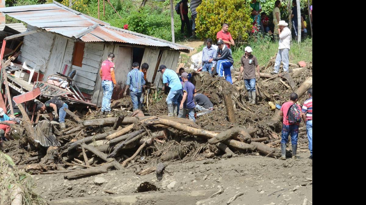 
Residents rescue belongings from houses damaged during an avalanche in Salgar, in Colombia's northwestern state of Antioquia, Monday, May 18, 2015. At least 49 people were killed when a mudslide triggered by heavy rains swept away homes before dawn.
