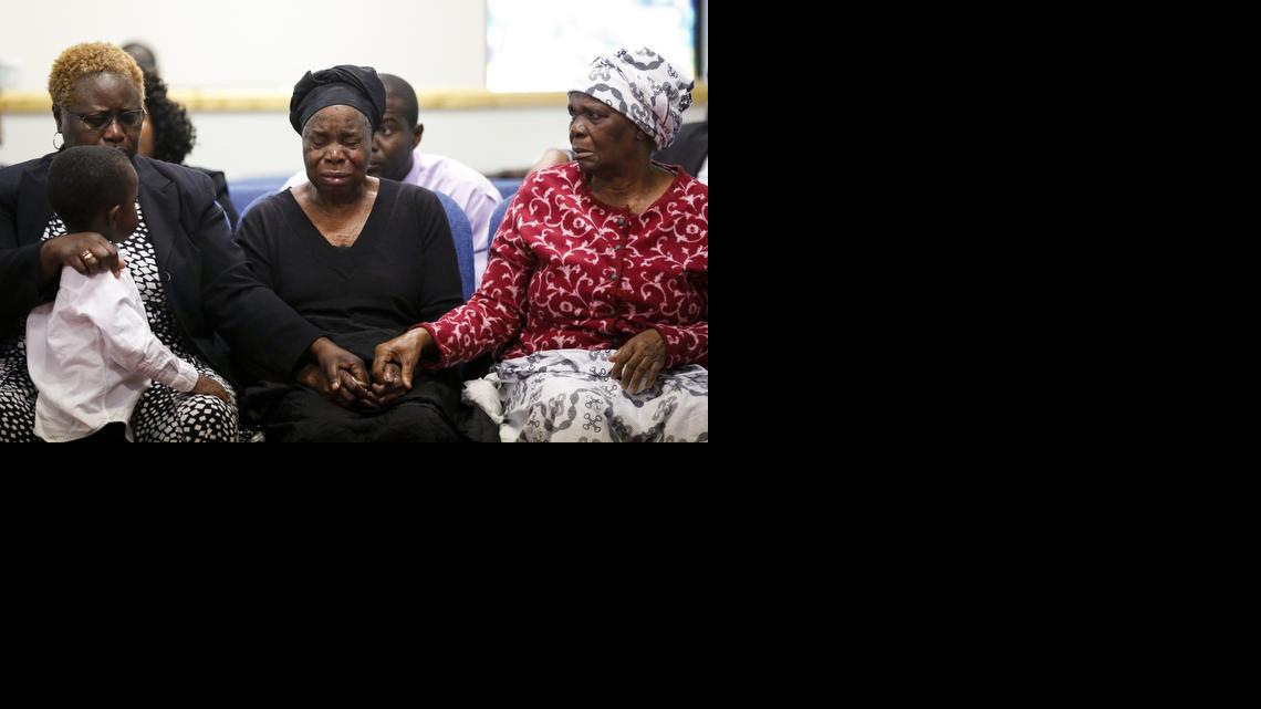 
Garteh Korkoryah, center, mother of Thomas Eric Duncan, is comforted during a memorial service, Saturday, Oct. 18, 2014, in Salisbury, N.C. Duncan died of Ebola in Dallas on Oct. 8. 

