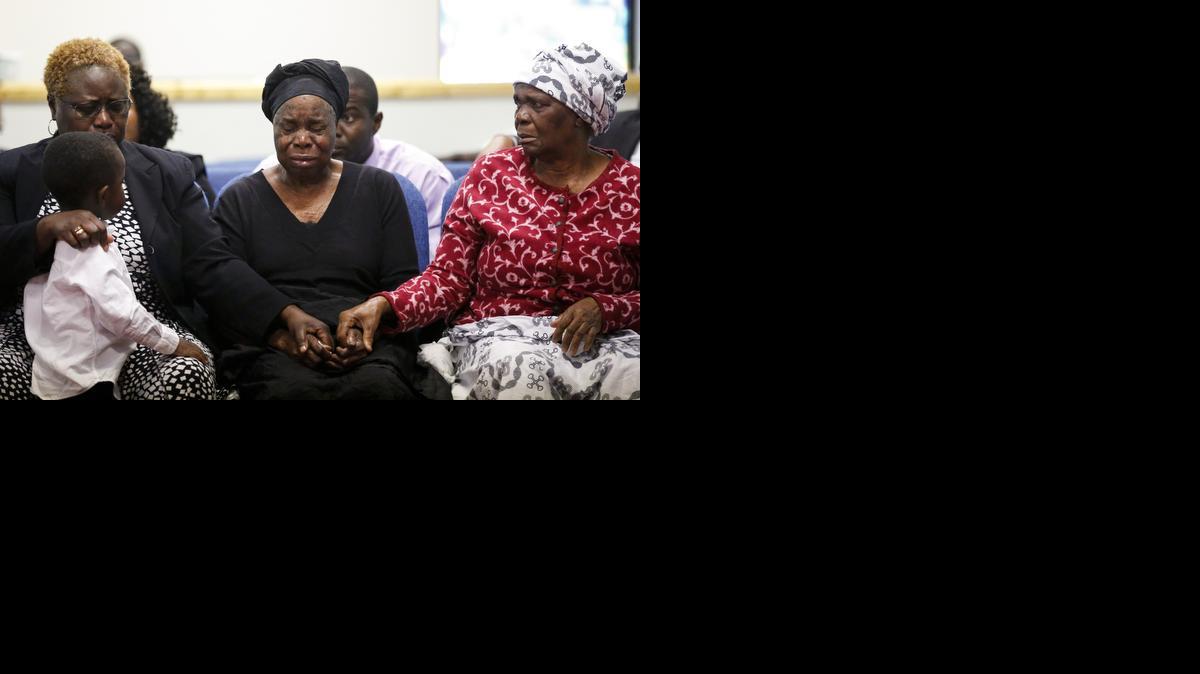 
Garteh Korkoryah, center, mother of Thomas Eric Duncan, is comforted during a memorial service, Saturday, Oct. 18, 2014, in Salisbury, N.C. Duncan died of Ebola in Dallas on Oct. 8. 

