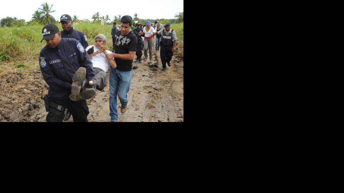 
Highway Reroute Movement leader Wayne Kublalsingh is taken away from the highway construction site in March 2014. 
