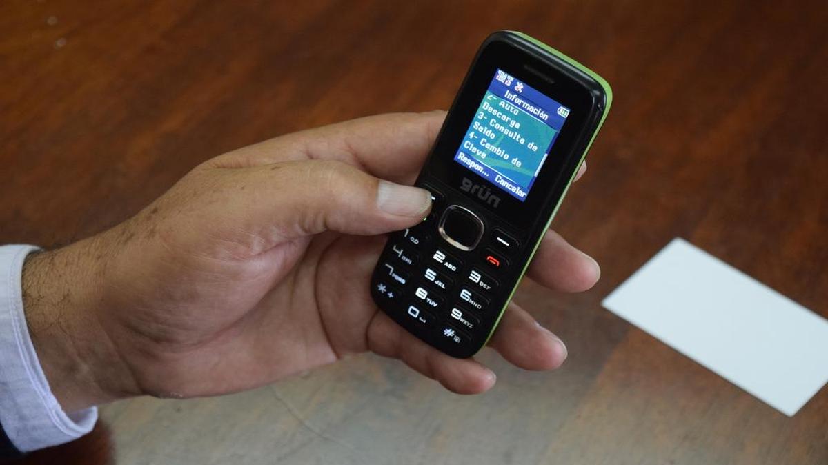 
Jaime Rojas shows off his mobile phone, which he uses as wallet for virtual currency in Ecuador. The Andean country recently became the only nation in the world to roll out its own government-backed e-money.
