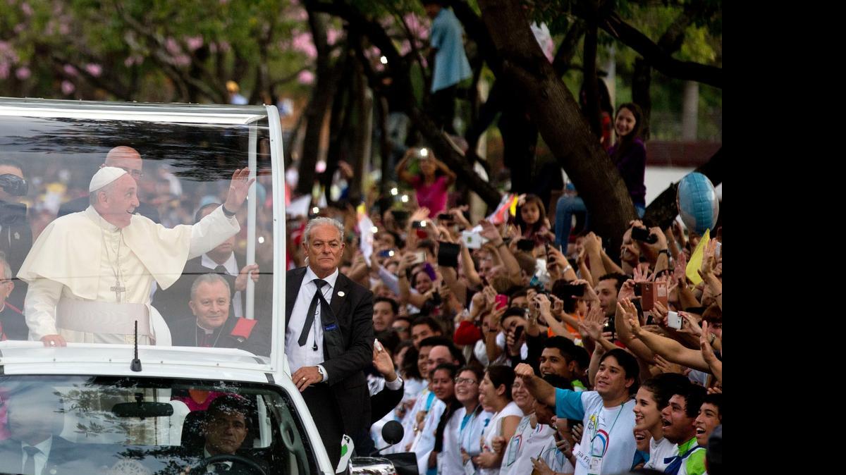 
People line the street where Pope Francis passes in his popemobile as he makes his way to the Leon Condu stadium for an event in Asuncion, Paraguay, Saturday, July 11, 2015. Pope Francis lauded the strength and religious fervor of Paraguayan women on Saturday while visiting the country's most important pilgrimage site, where thousands of his fellow Argentines joined with hundreds of thousands of local faithful to welcome Latin America's first pope.
