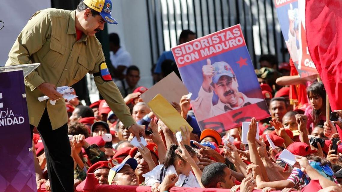 Venezuela’s President Nicolás Maduro reaches for letters written by supporters during a rally marking the anniversary of the failed 1992 coup led by late President Hugo Chávez in Caracas, Venezuela, Sunday, Feb. 4, 2018. Maduro will run for reelection in this year’s presidential election.