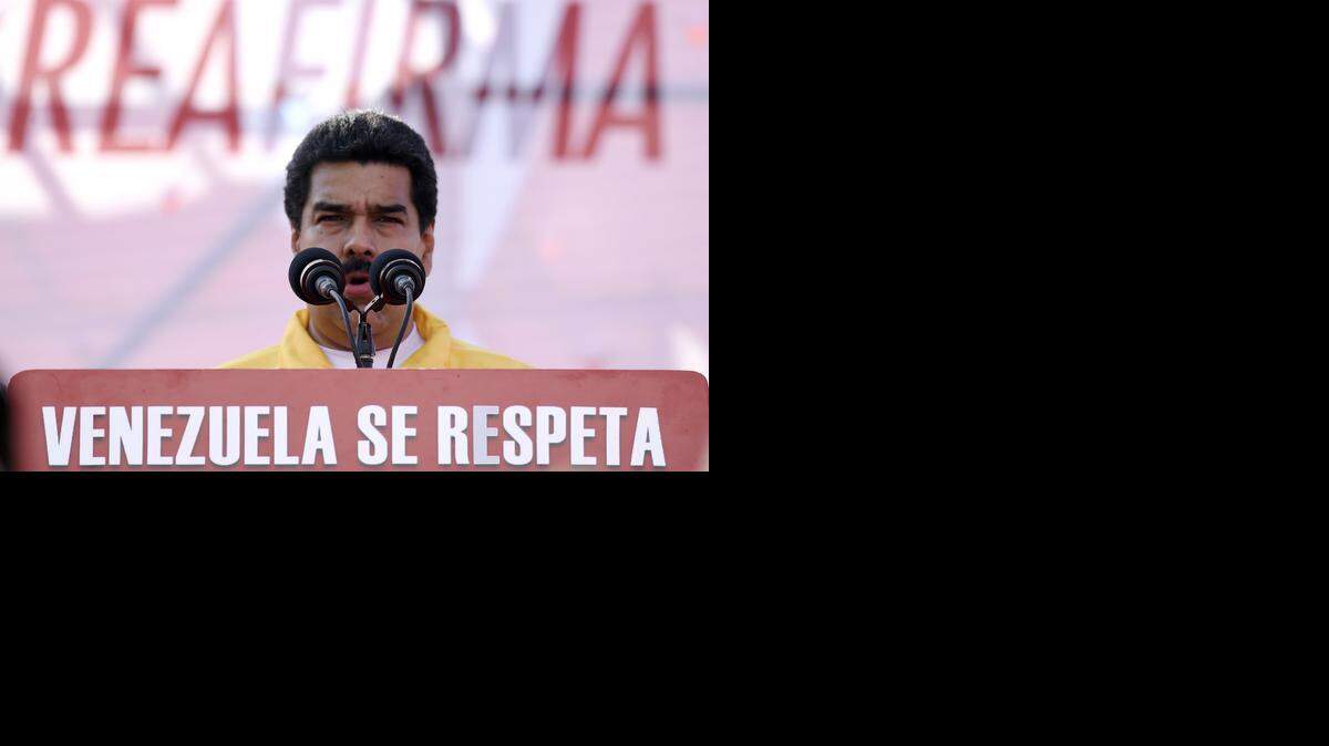 
Venezuelan President Nicolas Maduro delivers a speech during a demostration in Caracas on December 15, 2014. Thousands of government supporters took to the streets criticising the new sanctions against Venezuela, which the US Congress has approved after considering the government's treatment of opposition protests earlier this year a violation of human rights. 
