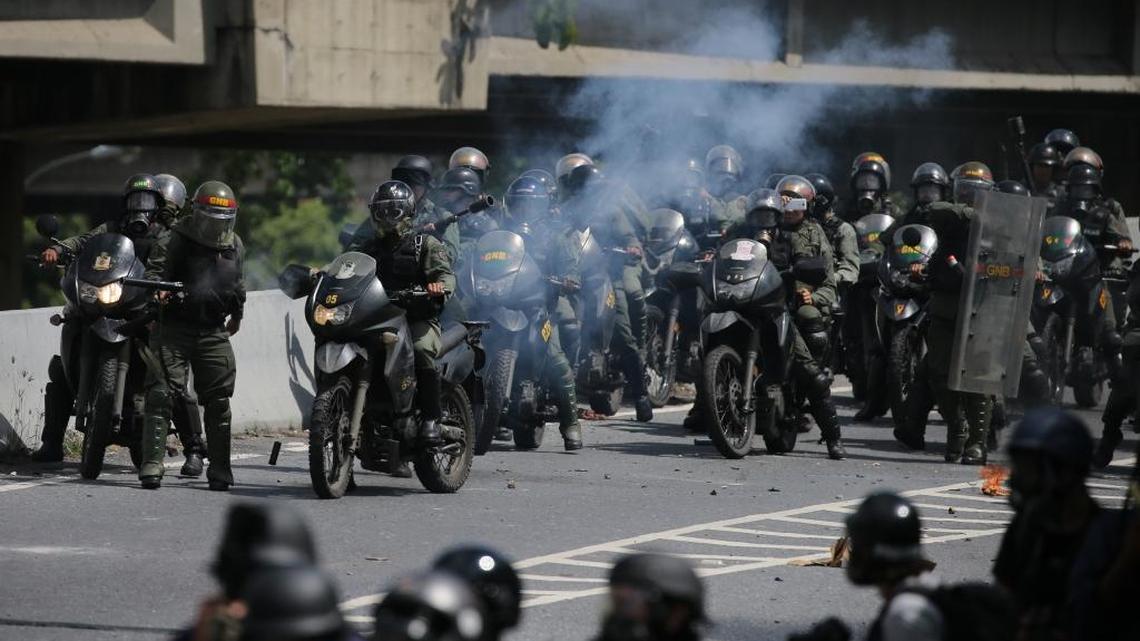 Bolivarian National Guards keep anti-government protesters from reaching the Supreme Court in Caracas, Venezuela, Thursday, July 6, 2017. Opposition protests demanding new elections and decrying triple-digit inflation, food shortages and worsening crime continue as President Nicolas Maduro pushes forward with his plan to draft a new constitution.