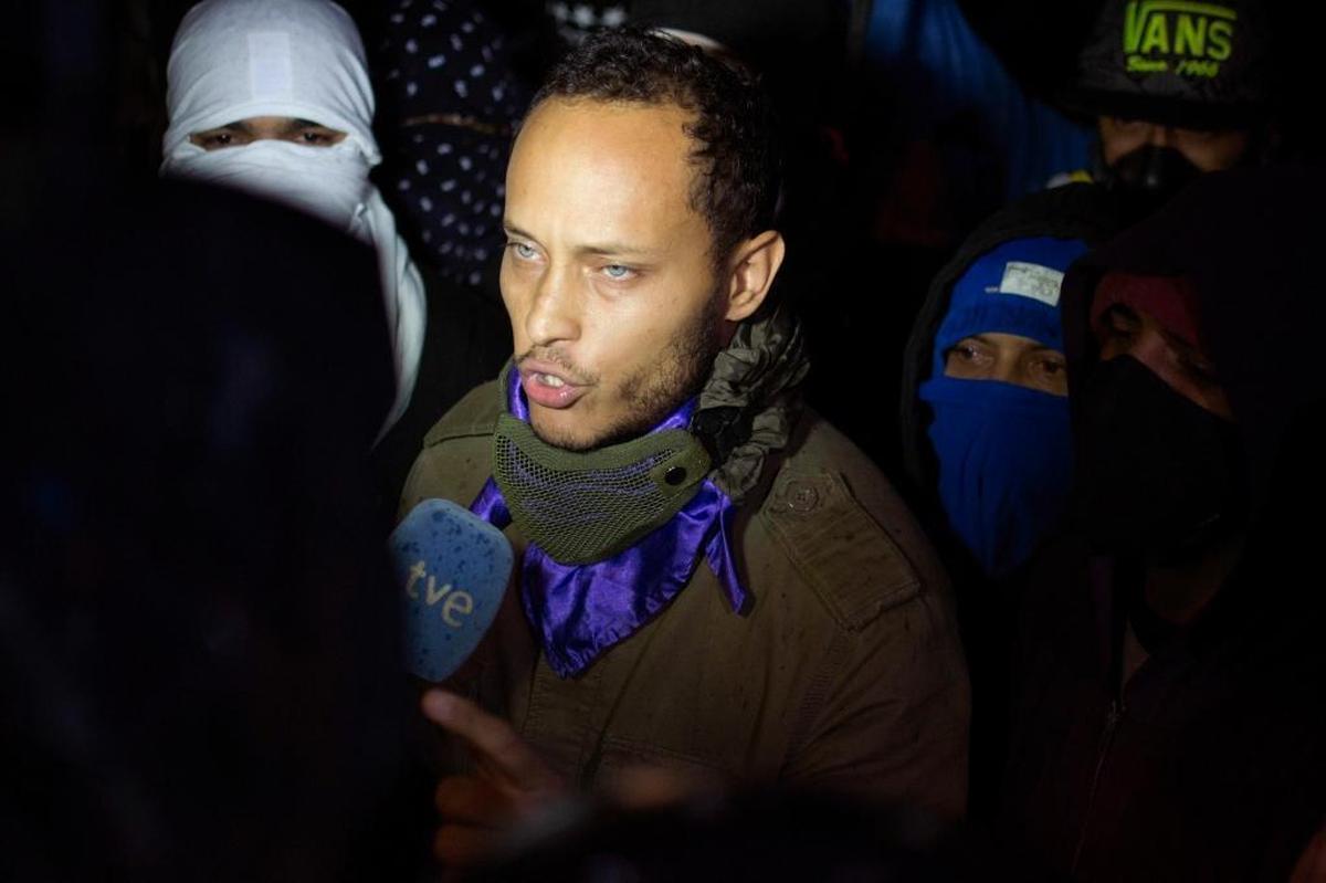 In this July 13, 2017, file photo, Óscar Pérez speaks to the press at a night vigil to honor the more than 90 people killed during three months of anti-government protests, in Caracas, Venezuela.