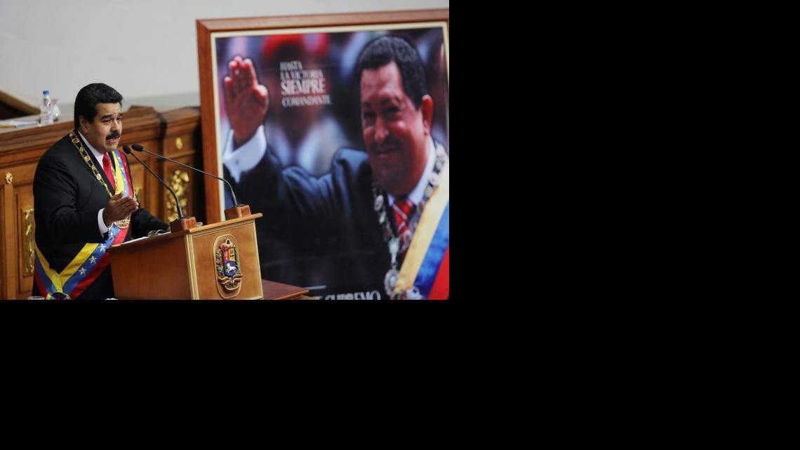 
BIG SPEECH: Venezuelan President Nicolas Maduro delivers his annual state-of-the-nation address Wednesday beside a framed poster featuring the late President Hugo Chavez at the National Assembly in Caracas.
