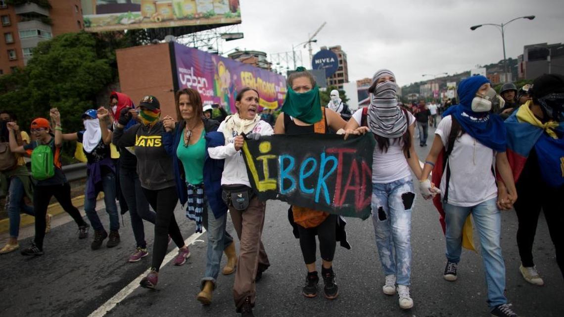 A group of women, one holding a sign that reads in Spanish “Freedom” march during an anti-government protest in Caracas, Venezuela, Thursday, April 13, 2017.