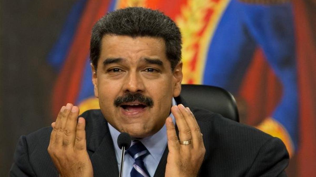 Venezuela's President Nicolas Maduro speaks during a press conference at the Miraflores presidential palace in Caracas, Venezuela, Tuesday, May 17, 2016. Maduro accused the United States of sabotage plans against Venezuela, saying they aim to create a scenario of violence to justify a foreign military intervention to remove him from power. Behind is a painting of independence hero Simon Bolivar.