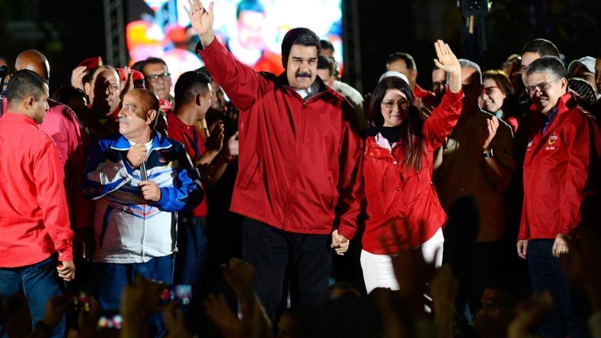 Venezuelan President Nicolas Maduro, center left, and his wife, Cilia Flores, center right, wave next to electoral candidates after the first results of the controversial election for a constituent assembly on July 31, 2017, on the Bolivar square in Caracas, Venezuela. Venezuelan authorities quelled an apparent military rebellion early Sunday, a ruling socialist party leader said.