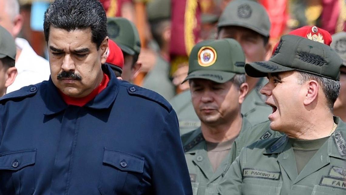 Venezuelan President Nicolás Maduro, left, along with the defense minister, Vladimir Padrino López, during a military parade in Caracas in December 2015. The Maduro government, hammered by increasing discontent, faces difficulty keeping control of its armed forces as signs emerge that officers’ loyalty is eroding amid international sanctions and U.S. hints that it would accept a coup.