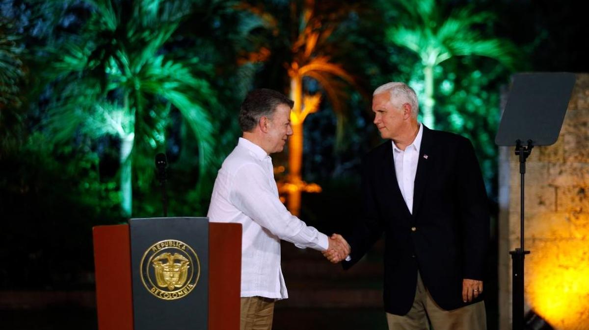 U.S. Vice President Mike Pence, right, shakes hands with Colombia's President Juan Manuel Santos during a press conference at the presidential guesthouse in Cartagena, Colombia, Sunday, Aug. 13, 2017. Cartagena is the first stop of Pence's weeklong trip to Latin America, that will also take him to Argentina, Chile and Panama.
