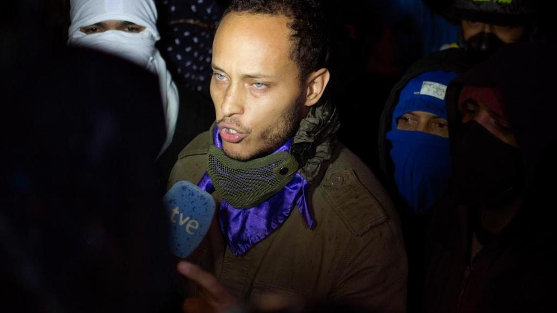 Óscar Pérez speaks to the press in July 2017 at a night vigil to honor the more than 90 people killed during three months of anti-government protests in Caracas, Venezuela.