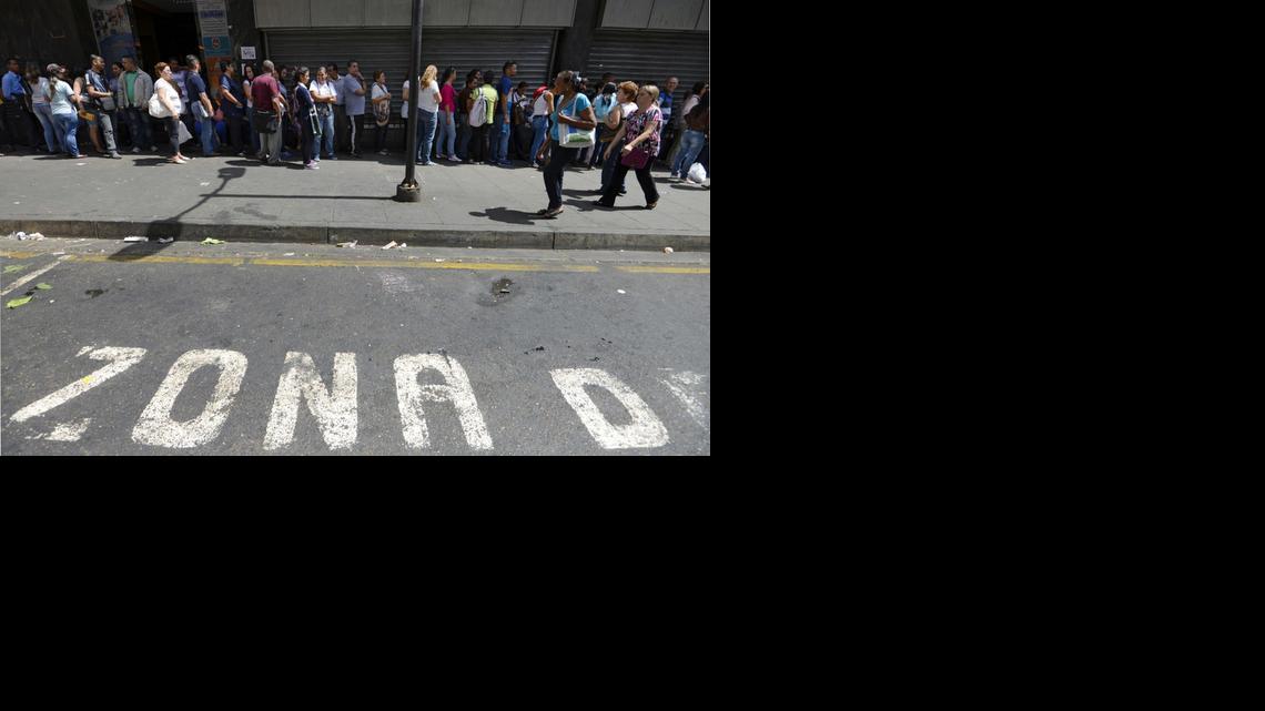 
People queue outside a supermarket in Caracas on Monday, Feb. 2, 2015. 
