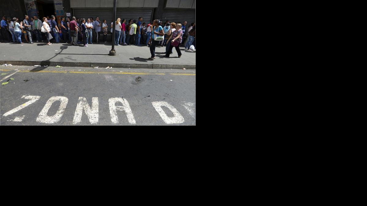 
People queue outside a supermarket in Caracas on Monday, Feb. 2, 2015. 
