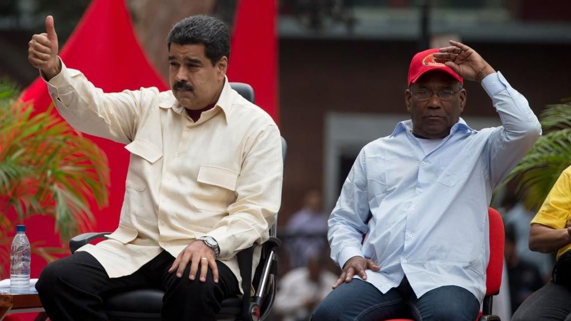 Venezuelas President Nicolas Maduro flashes a thumbs up sitting next to Vice President Aristobulo Isturiz in Caracas on April 19.