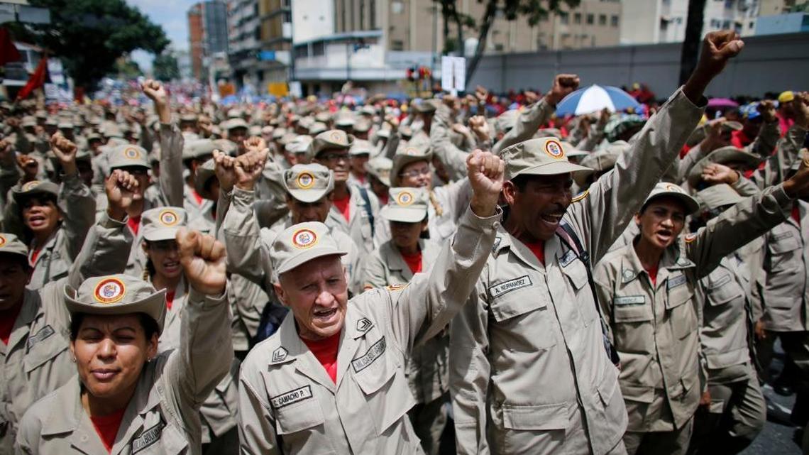 Venezuelan Bolivarian Militia members shout slogans agains the Unites States during an anti-imperialist march to denounce Trump's talk of a "military option" for resolving the country's political crisis, in Caracas, Venezuela, Monday, Aug. 14, 2017.
