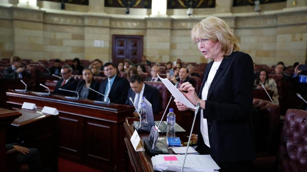 Former Venezuelan Chief Prosecutor Luisa Ortega shows documents that she claims prove that Venezuela's President Nicolás Maduro took bribes for the Brazilian construction company Odebrect, in Bogotá, Colombia, Tuesday, April, 3, 2018. A group of exiled jurists known as the ‘Supreme Court in Exile,’ met in Colombia's capital to hear corruption allegations against Maduro, launching a largely symbolic process that could tarnish the embattled leader's reputation.