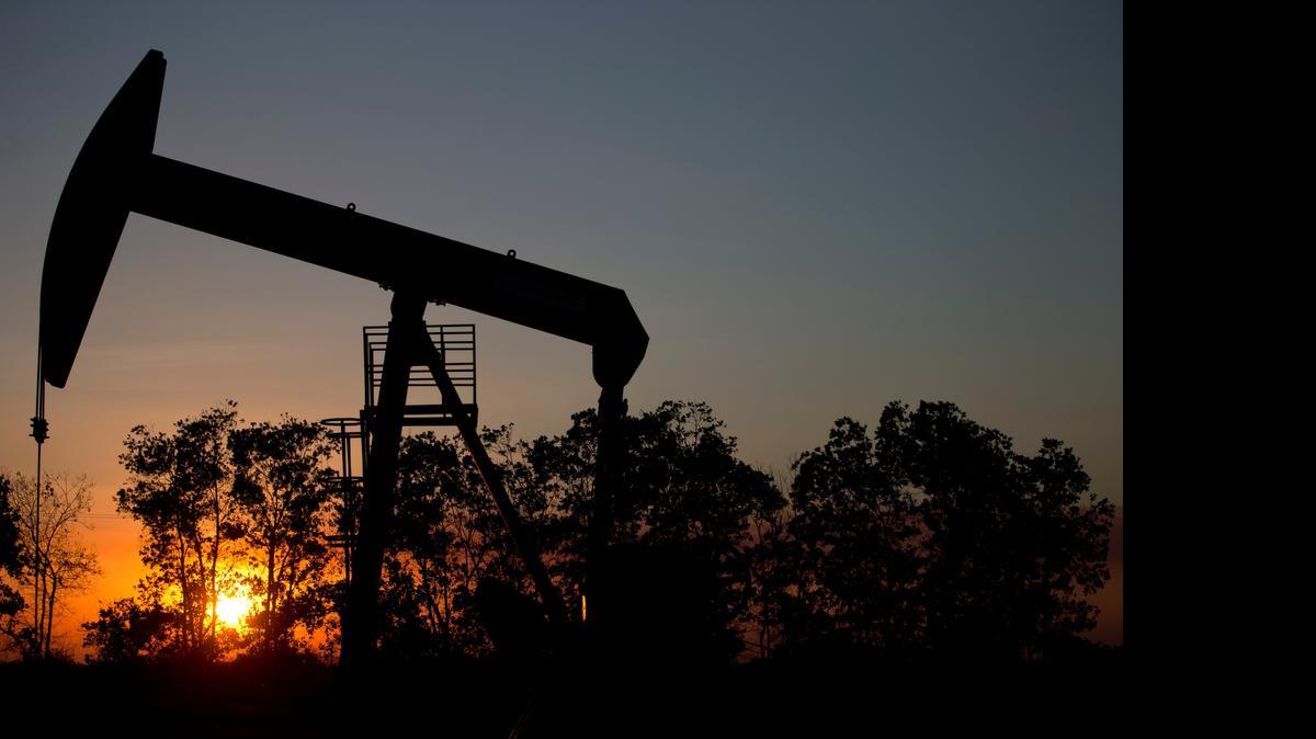 
In this Feb. 19, 2015 photo, the sun sets behind an oil well in a field near El Tigre, a town within Venezuela's Hugo Chavez oil belt, formally known as the Orinoco Belt. President Nicolas Maduro, whose approval rating has plunged to around 25 percent, has no choice but to lean on state-fun oil company PDVSA to help Venezuela back on its feet and has been quietly trying to lure back foreign drillers. 

